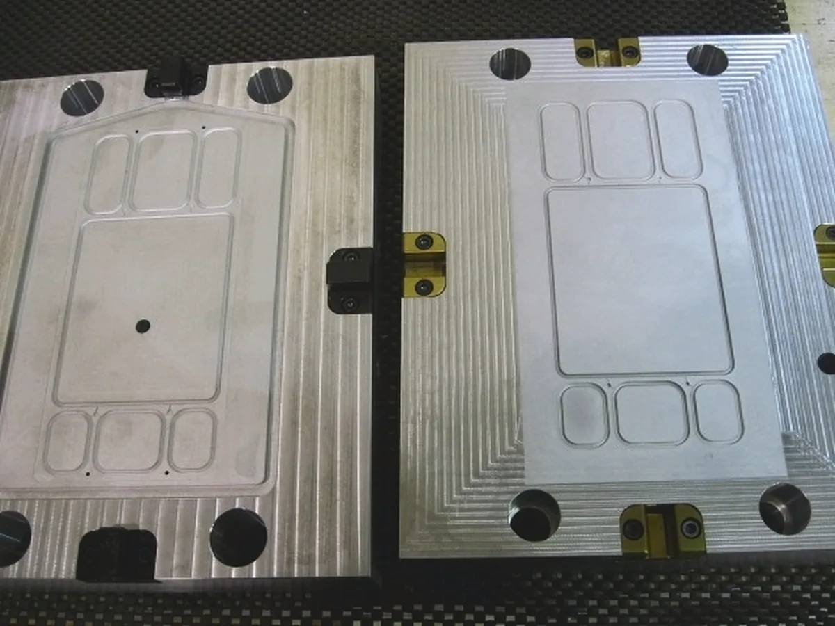 Matched pair of aluminum mold plates with machined pockets