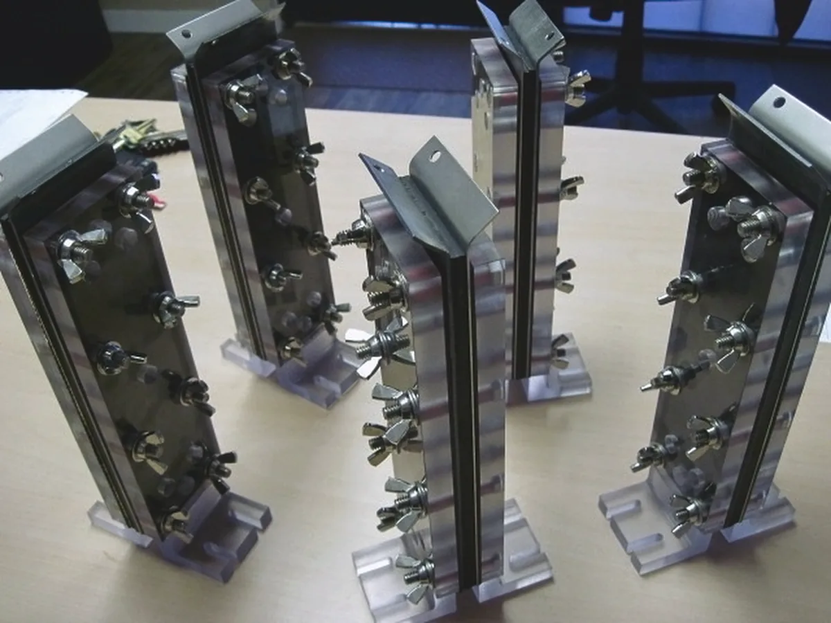 Workholding fixtures with wing-nut clamps holding sheet-metal blades