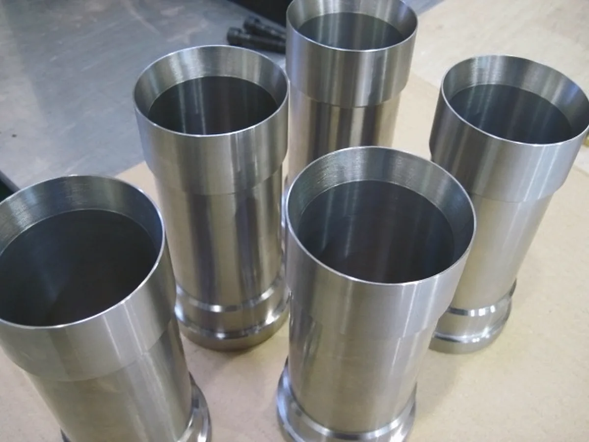 Five stainless steel sleeves with stepped and grooved ends