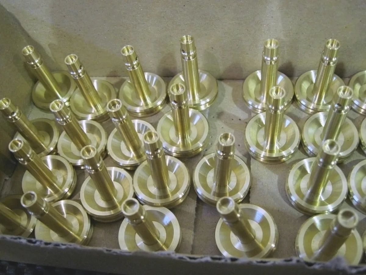 Production run of brass valve stems in a shipping box