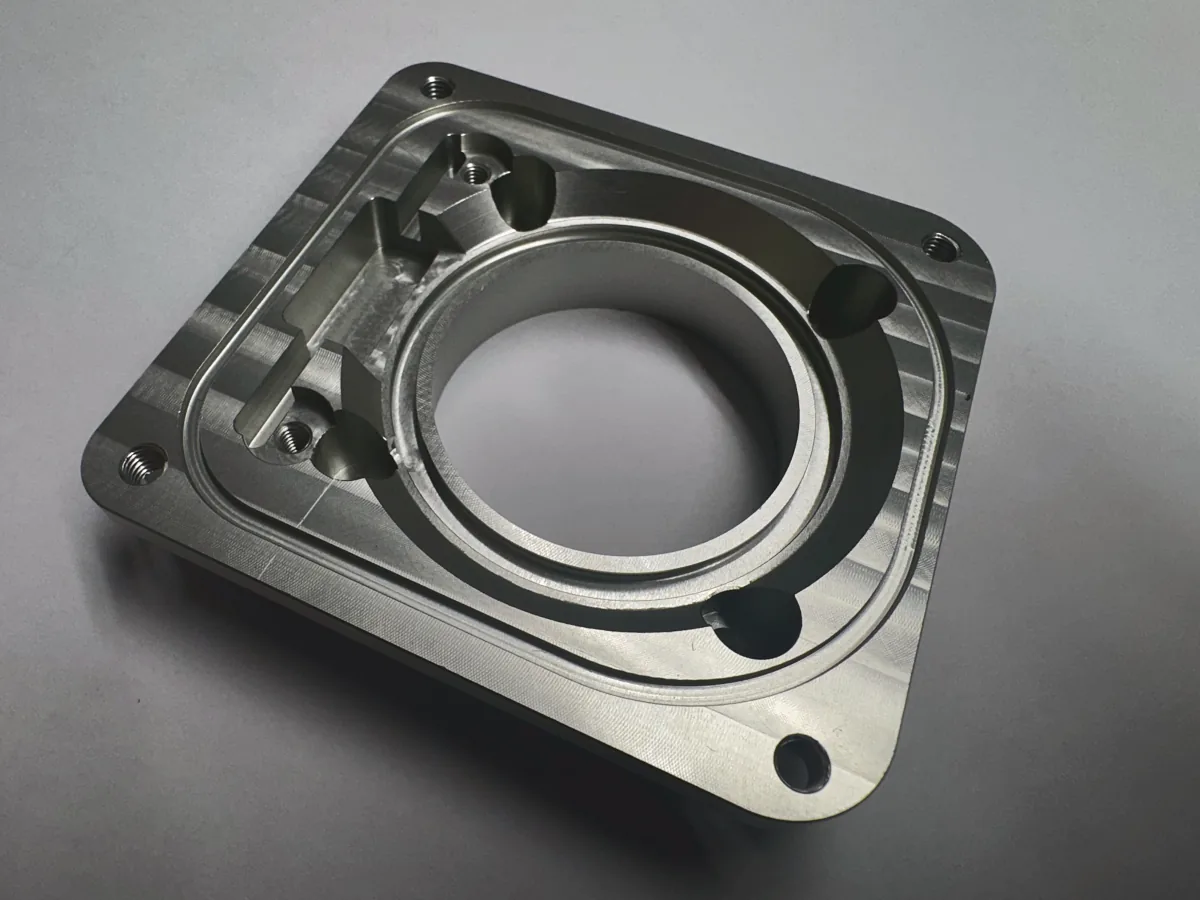 Aluminum housing with a large bore, sealing face and tapped holes