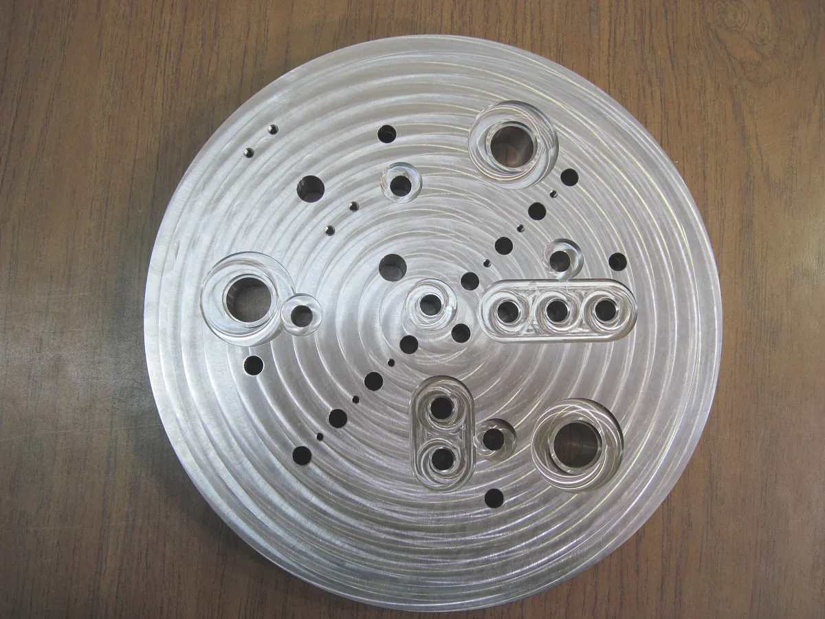 Circular aluminum plate with a spiral-machined face and ported bosses