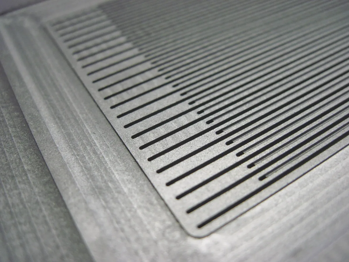 Thin plate with a dense field of fine parallel slots
